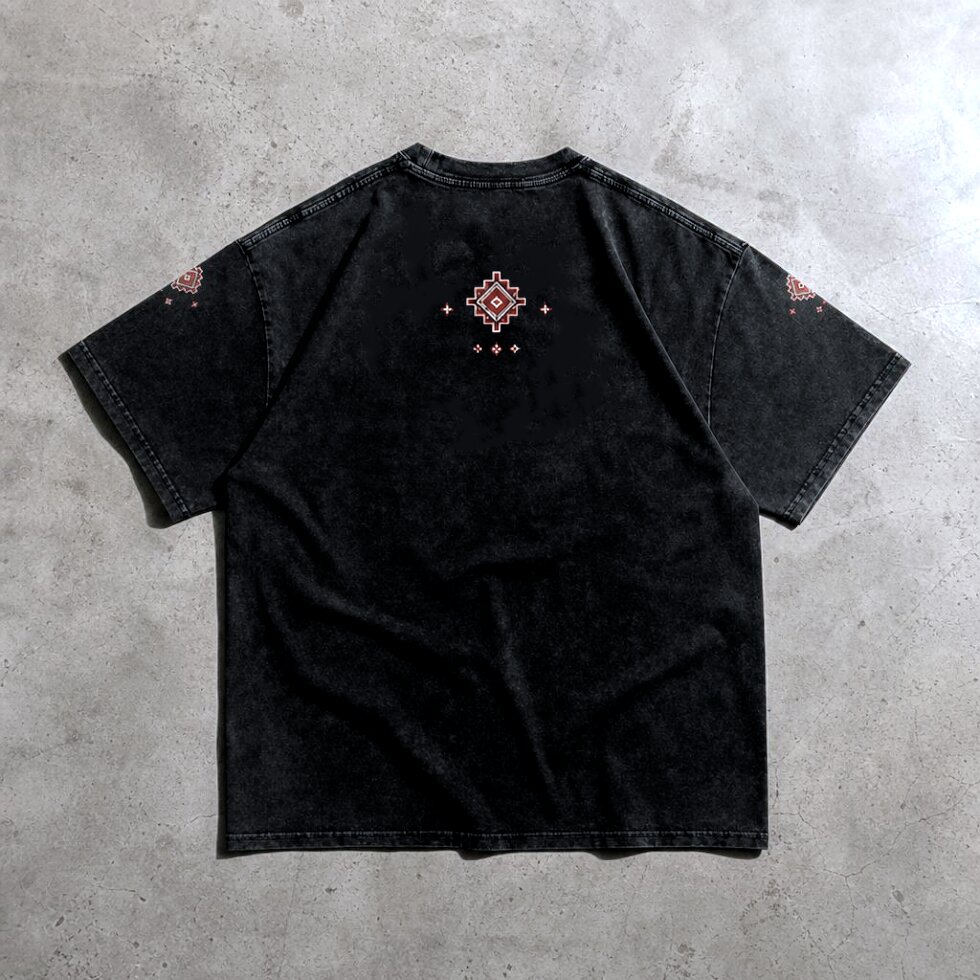 Black acid wash oversized drop shoulder t-shirt featuring a red geometric Persian-inspired rug artwork on the front chest, with matching ornamental details on the sleeves and upper DTF printed,